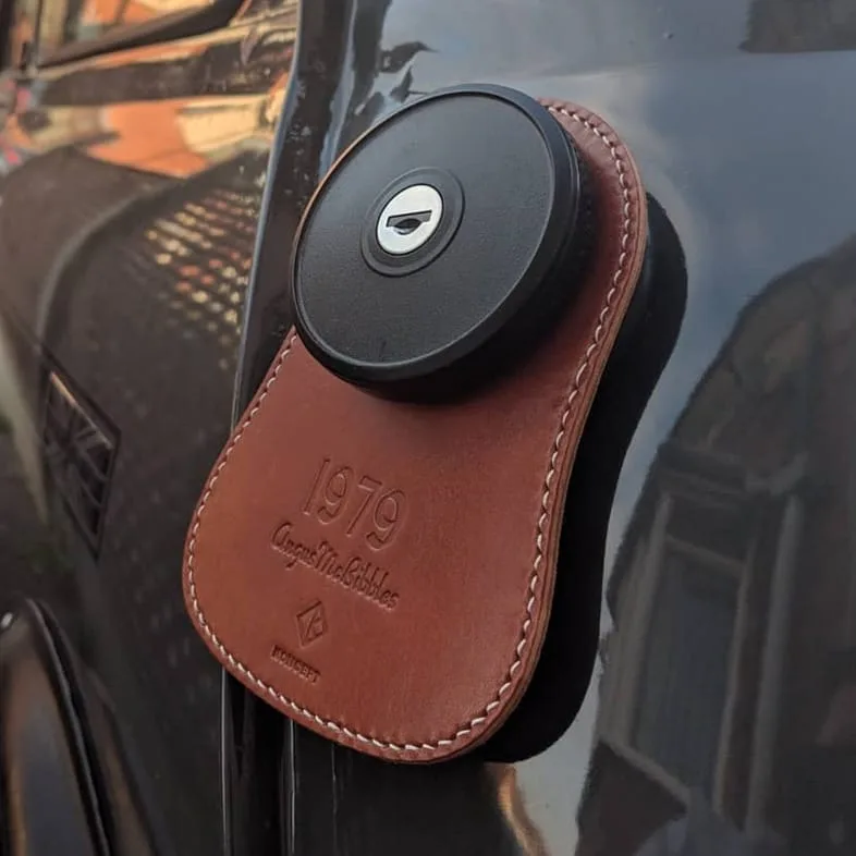 Koncept Studios brown leather fuel bib with custom engraving installed on a classic Mini