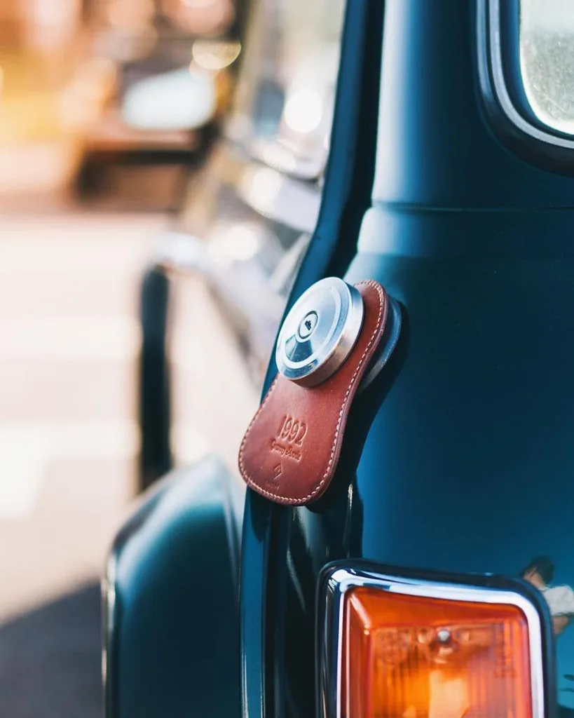Koncept Studios brown leather fuel bib installed on a black classic Mini