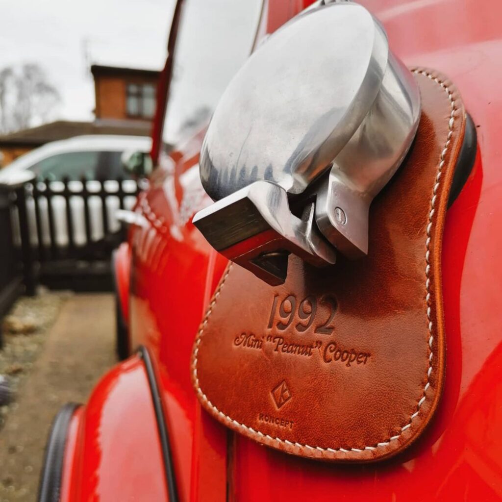 Koncept Studios classic mini fuel bib on red vintage Mini Cooper, close-up shot