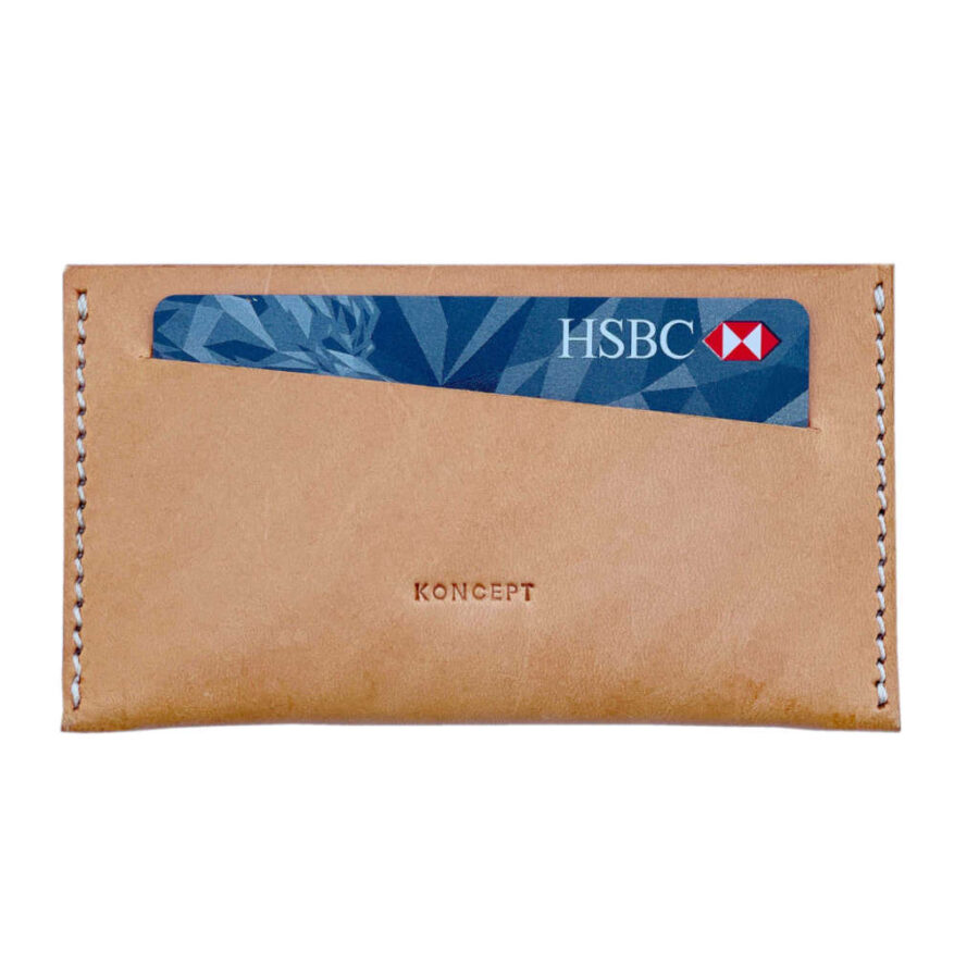 Koncept Studios natural leather cardholder with a credit card partially visible