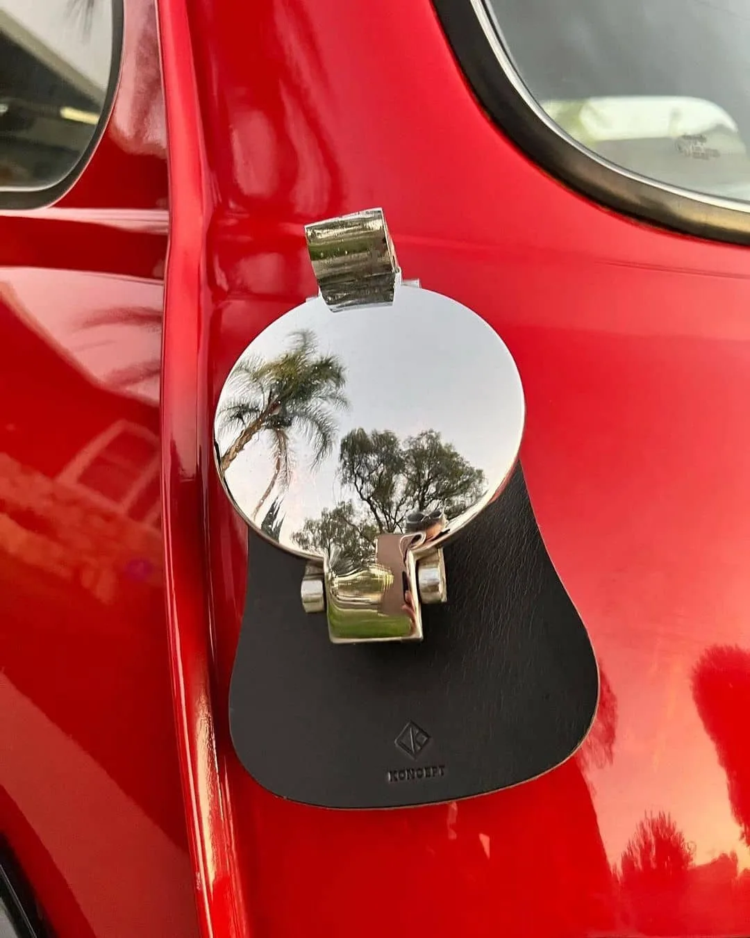 Koncept Studios black leather fuel bib installed on a red classic Mini