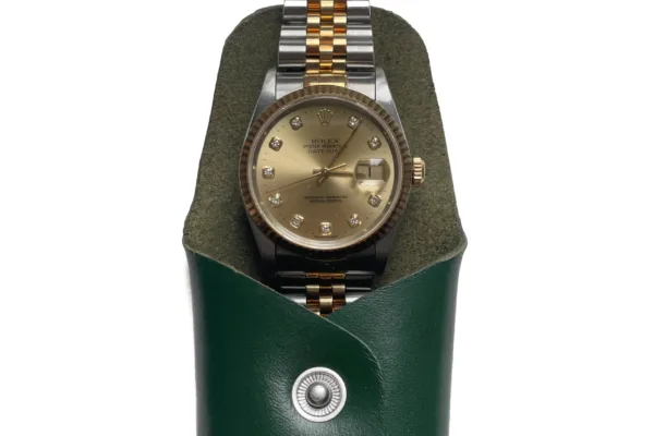 Green leather pouch with Rolex watch